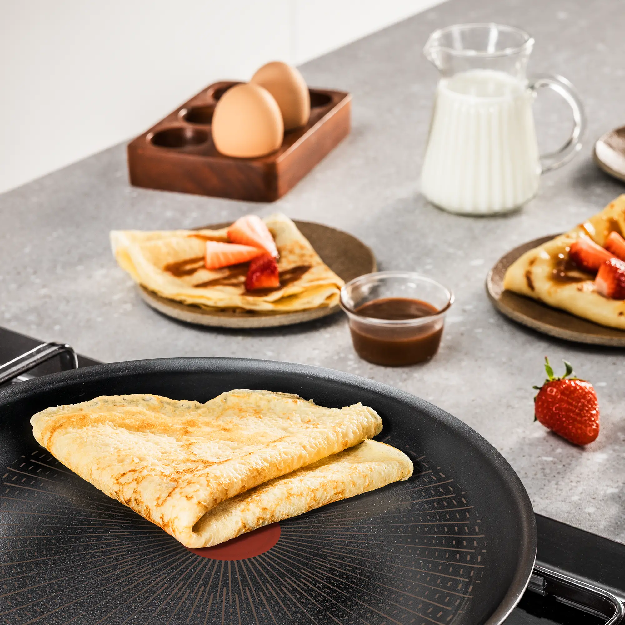 Tefal Excellence+ Induction FusionCore Non-Stick Pancake Pan 25cm on kitchen bench with cooked crepe