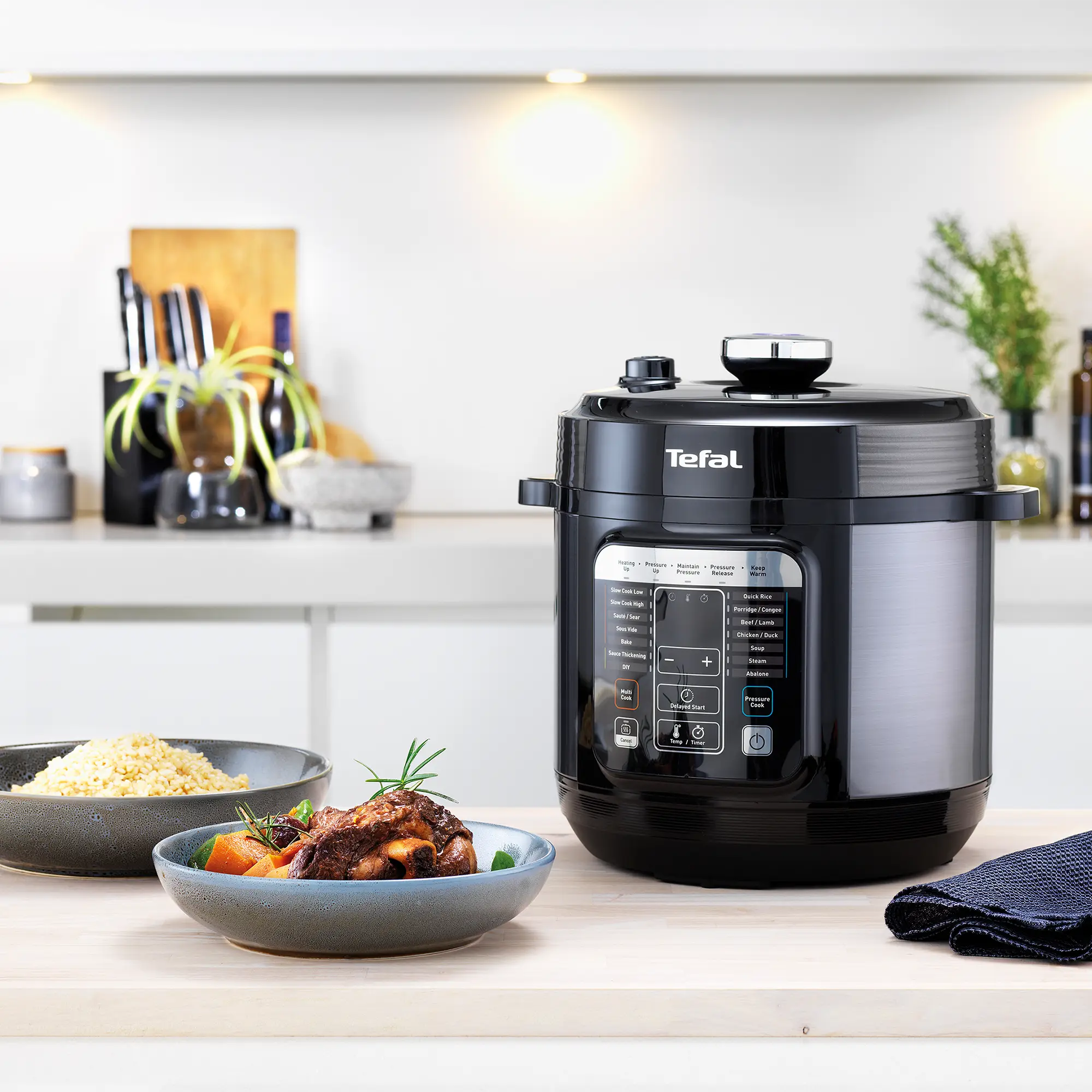 Tefal Home Chef Smart Multicooker CY601 Rice & Multicooker on kitchen counter with food