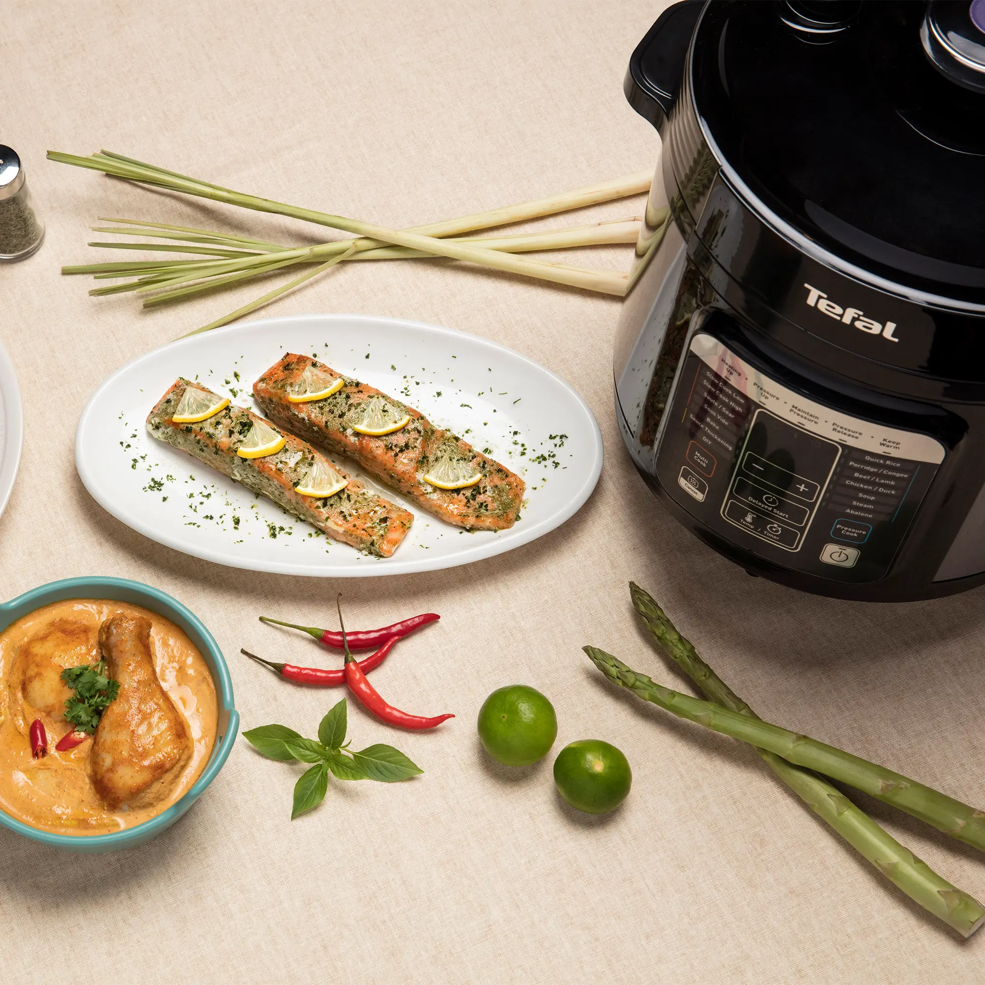 Tefal Home Chef Smart Multicooker CY601 Rice & Multicooker on kitchen counter with fish and chicken
