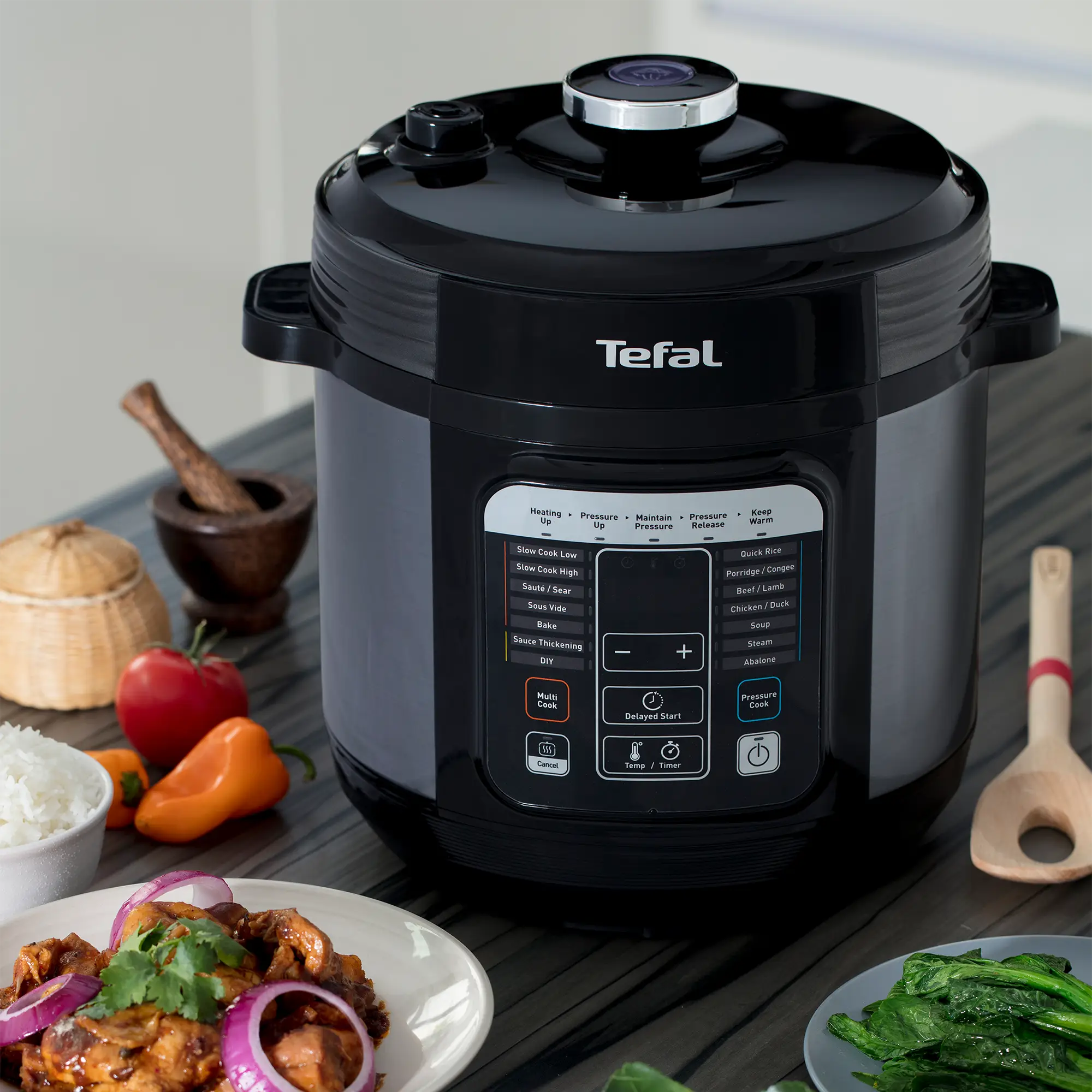 Tefal Home Chef Smart Multicooker CY601 Rice & Multicooker on kitchen bench with food