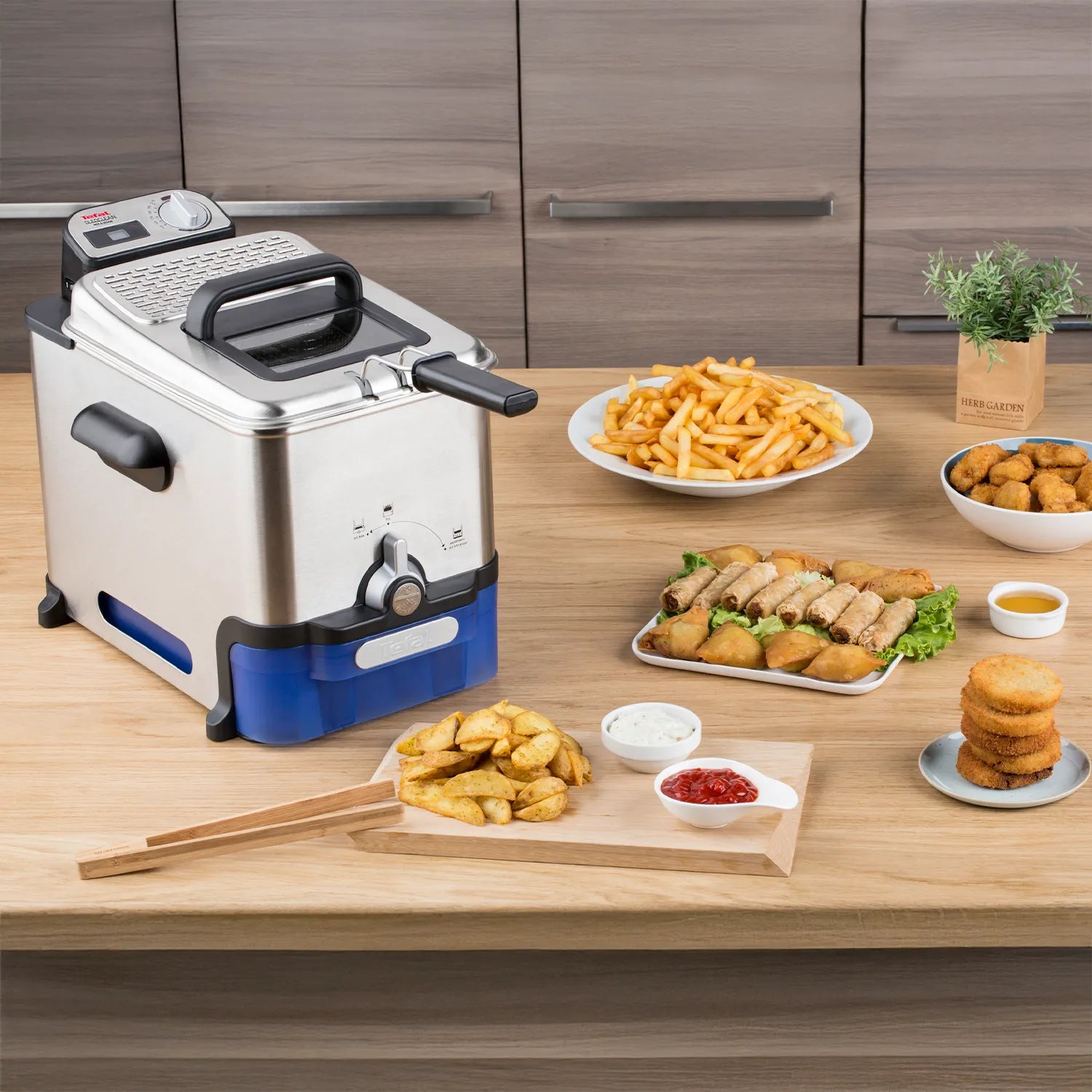 Tefal Oleoclean Pro Deep Fryer FR8040 on bench with fried food