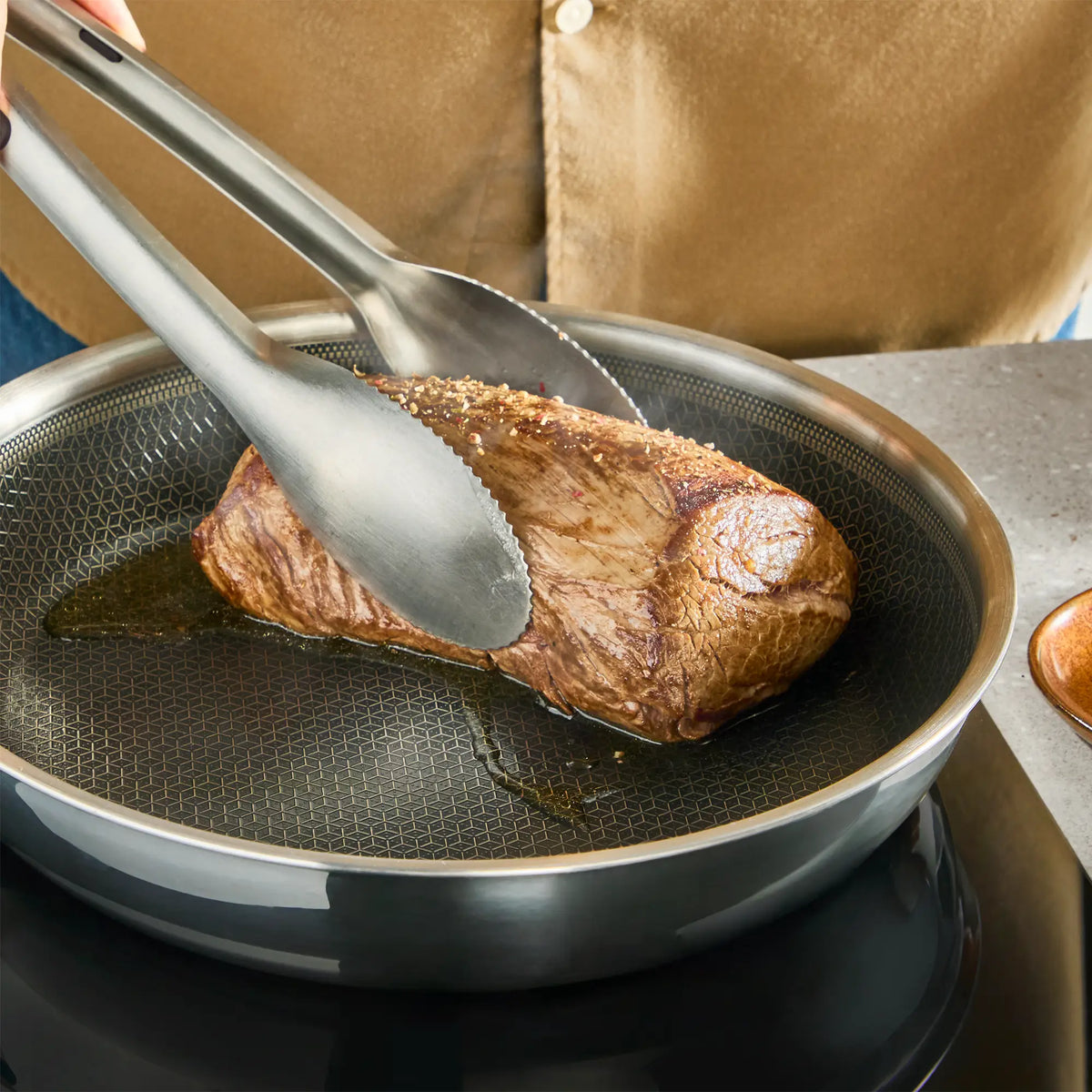Tefal Master Induction Stainless Steel Ceramic Hybrid Mesh Frypan searing meat